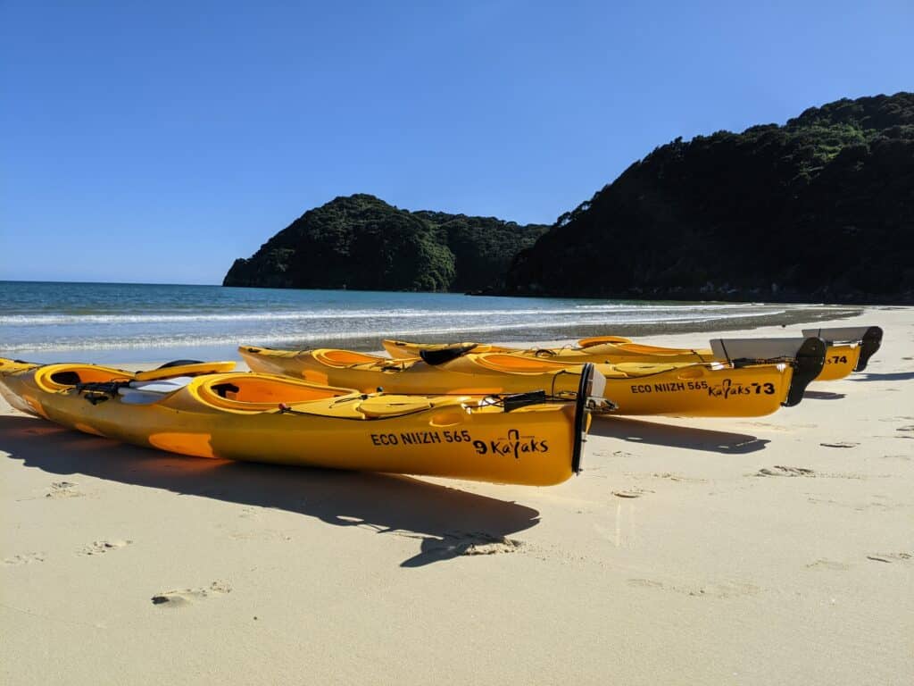 Kayaks on the beach for lunch - abel tasman trips