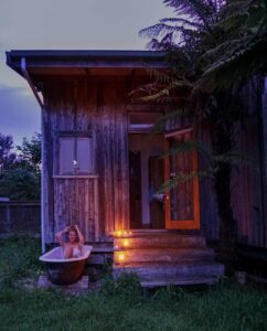 The outdoor tub at the beach bach for the barn cabins and camp